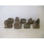 A collection of nine stone hedgehog garden ornaments, many marked with Hilltop Products