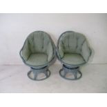 A pair of retro bamboo "egg" style swivel chairs