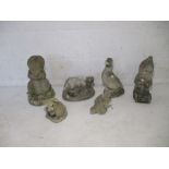 Six stone garden ornaments, including a gnome, otter, rabbit etc.