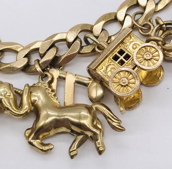 A 9ct gold charm bracelet with various novelty charms including a gypsy caravan which opens to - Image 3 of 5