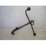 An antique cast iron ships anchor