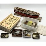 A part finished vintage model boat along with a box of parts and tools plus a quantity of Model