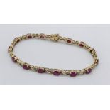 A diamond and ruby bracelet set in 9ct gold, total weight 8.4g