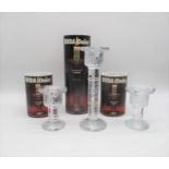 A pair of boxed Boda Daisy glass candle sticks, along with one other