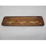 A small rectangular Newlyn copper dish with embossed fish.