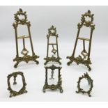 Three Rococo style brass easels along with three smaller brass photo frames