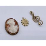 A 9ct gold framed cameo brooch, a 9ct brooch in the form of a Treble Clef (weight 2.9g) and a yellow