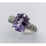 A 9ct white gold amethyst ring set with diamonds to the shoulders