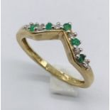 An emerald and diamond ring in 9ct gold