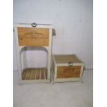 Two storage boxes made from wine crates,in wooden frames, with lids. One has shelf under.