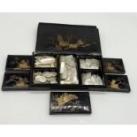 A large collection of various shaped Chinese Mother of Pearl gaming counters in lacquered box (A/