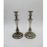 A pair of weighted silver plated candlesticks.