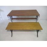 A garden table with non matching bench, both with cast iron ends.
