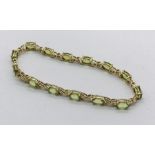 A 9ct gold bracelet set with peridots, total weight 7.8g