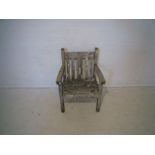A weathered wooden garden chair.