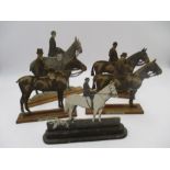 A collection of five "Fret Portraits" on wooden stands, each depicting a horse and rider - three