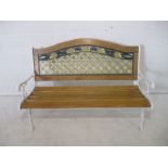 A painted cast iron garden bench with wooden slatted seat, length 130cm.