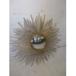 A vintage style sun burst convex mirror