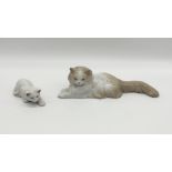 A Royal Copenhagen cat figure along with one other.
