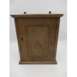 A small oak wall hanging cupboard - height 31cm