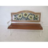 A painted cast iron garden bench, with wooden slatted seat
