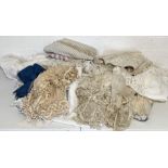 A collection of antique and vintage table linen, lace, clothing etc.