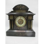 A slate mantle clock with inscription on silver plate.