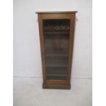 A glass fronted display cabinet - height 133cm