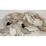 A collection of antique and vintage table linen, lace, clothing etc.