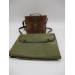 A pair of World War 1 field glasses with a leather case. Case is inscribed with broad arrow mark,