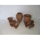 A quantity of terracotta garden pots, including a large Yorkshire flower pot.