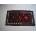 A red ground Eastern rug with lead seal
