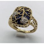 An enamel and diamond ring set in 9ct gold