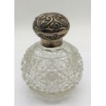 A silver topped scent bottle dated 1903