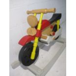 A wooden master Range Ltd rocking motorbike.