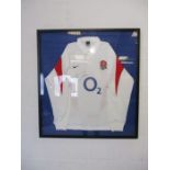 A framed England rugby shirt, signed by former World Cup winner captain Martin Johnson