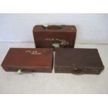 Three vintage leather suitcases