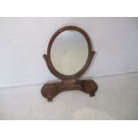 A Victorian toilet mirror with two lidded storage compartments.