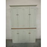 A large painted four door cupboard.