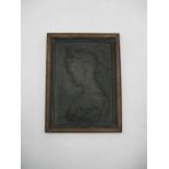 A framed bronze plaque of a lady.