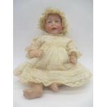 An antique bisque headed Kammer & Reinhardt doll in period lace clothing