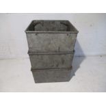 Three galvanised stackable square storage trays