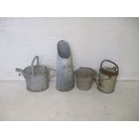 A galvanized metal watering can, along with one other, a bucket etc.