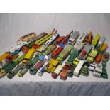 A collection of various loose play worn die-cast vehicles including cranes, car transporters,