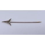 An 18ct gold and platinum stick pin in the form of an arrow with inset old cut diamond. Total weight