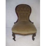 A Victorian nursing chair with button back.