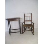 An oak occasional table with an antique country rocking chair.