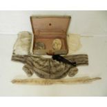 A quantity of vintage furs, including a mink scarf, two hats, contained within a vintage suitcase.