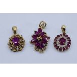 Three 9ct gold pendants set with rubies, total weight 4.4g