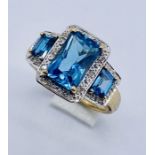 A topaz three stone ring set in 9ct gold